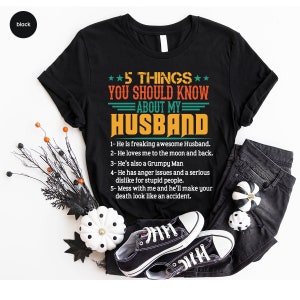May include: Black t-shirt with a white and orange graphic that says "5 Things You Should Know About My Husband" with a list of five humorous reasons why.