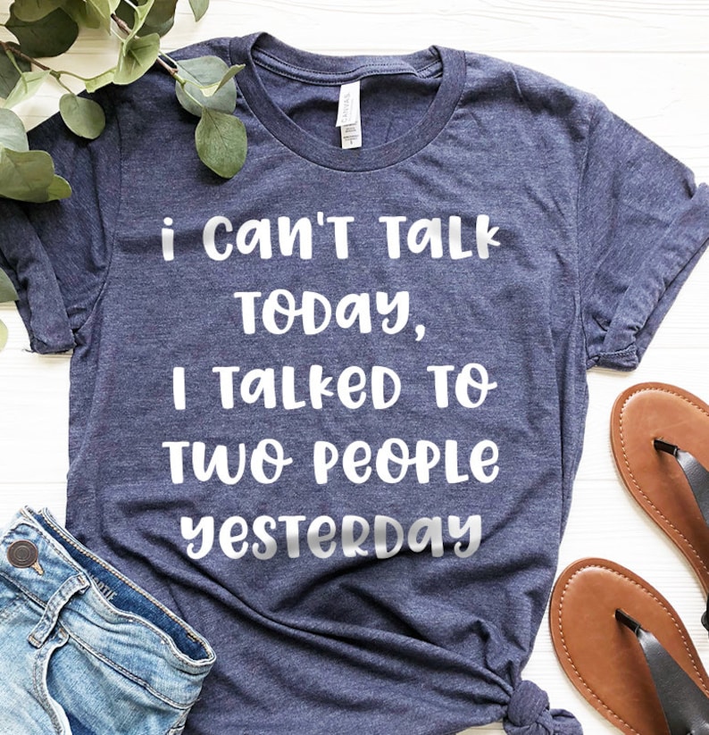 May include: A navy blue t-shirt with white text that reads "i can't talk today, i talked to two people yesterday".