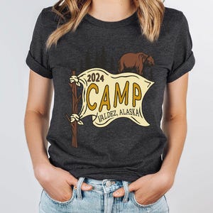 a woman wearing a t - shirt that says camp