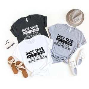 May include: Three t-shirts with the text "DUCT TAPE CAN'T FIX STUPID BUT IT CAN MUFFLE THE SOUND" printed on them. The shirts are in white, grey, and dark grey.