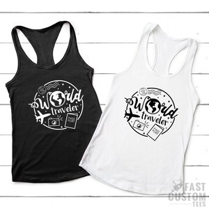 May include: Two tank tops with a white graphic design of a globe, airplane, camera, and passport with the text "World Traveler". One tank top is black and the other is white.