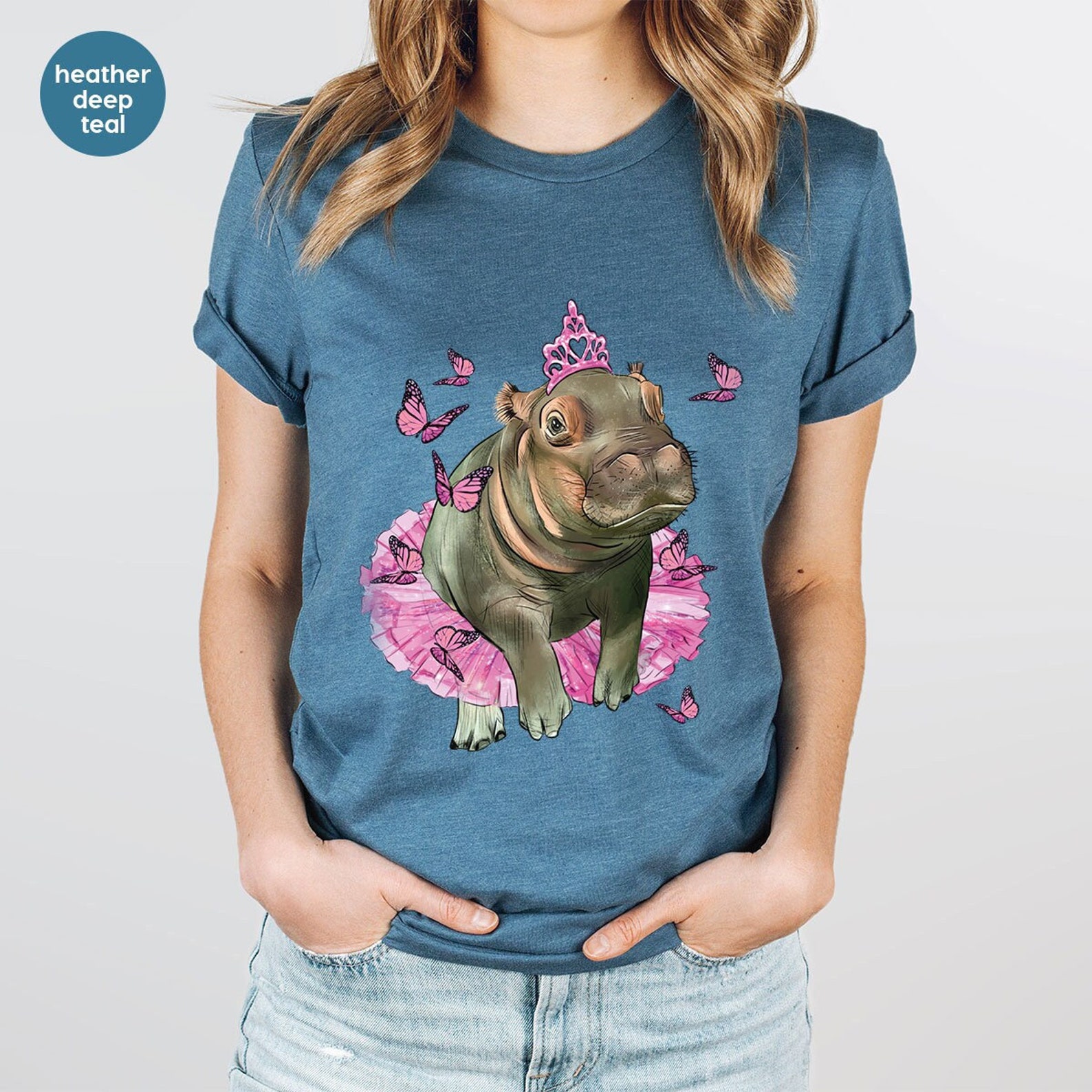 blue T-shirt with a hippo on the front wearing a pink dress.