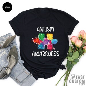 May include: Black t-shirt with a colorful puzzle piece and the text "Autism Awareness".
