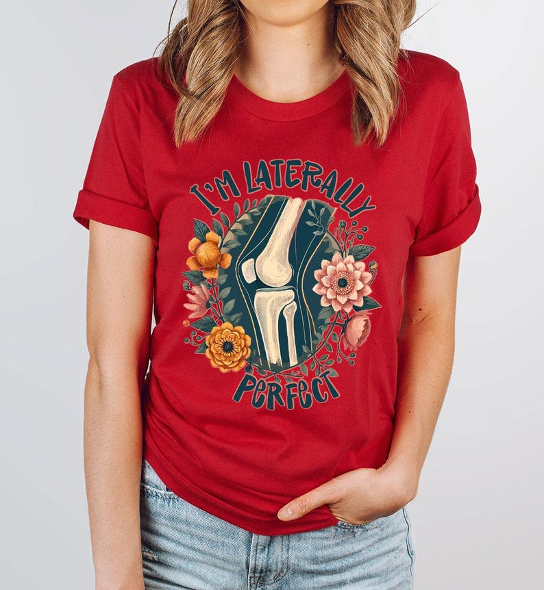a woman wearing a red t - shirt with a picture of a woman's