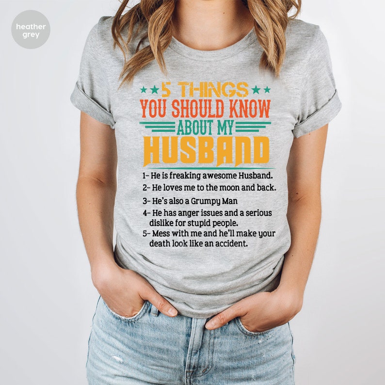 May include: A heather grey t-shirt with a humorous message about a husband. The text reads "5 THINGS YOU SHOULD KNOW ABOUT MY HUSBAND" and lists five humorous points about a husband.