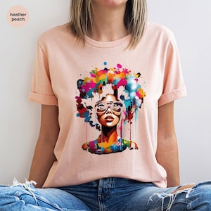 a woman wearing a t - shirt with a picture of a woman's face