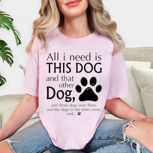 A woman wearing a pink t-shirt with a humorous text printed on it.