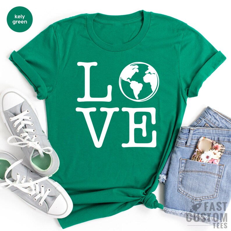 May include: A kelly green t-shirt with the word "LOVE" printed in white. The "O" in "LOVE" is replaced with a white outline of the Earth.