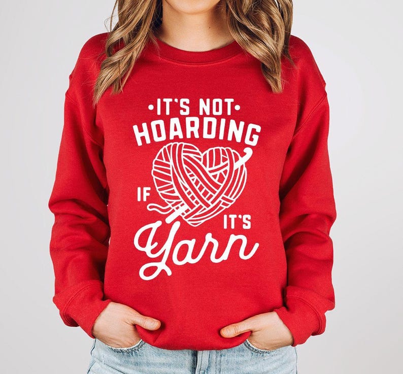 a woman wearing a red sweater that says it's not hoarding if it