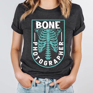 a woman wearing a black shirt with a skeleton on it