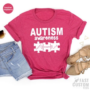 May include: Heather raspberry t-shirt with the text "AUTISM awareness" and three puzzle pieces that say "ACCEPT", "UNDERSTAND", and "LOVE".