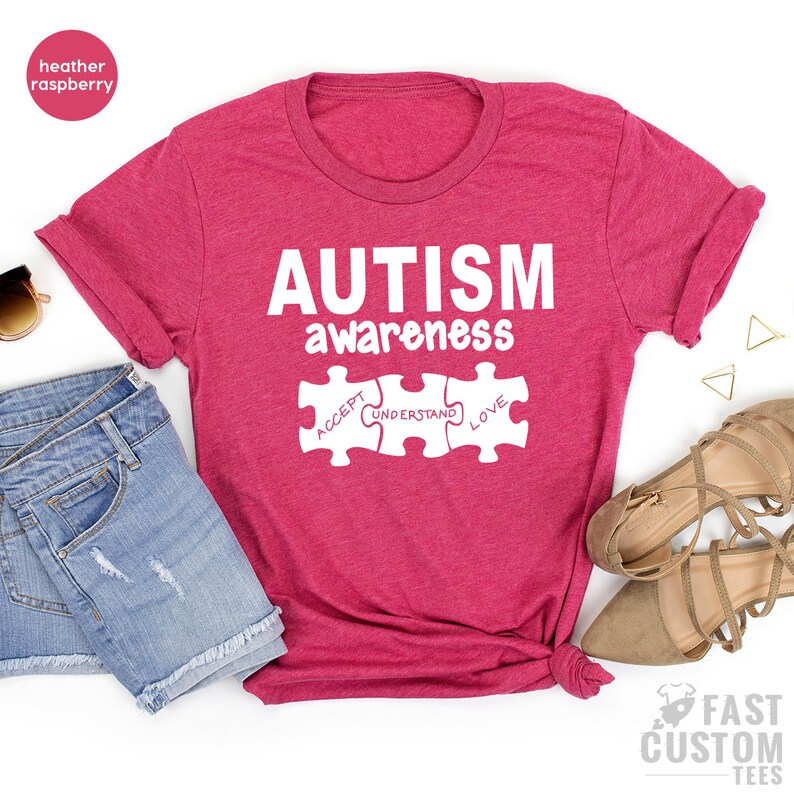 May include: Heather raspberry t-shirt with the text "AUTISM awareness" and three puzzle pieces that say "ACCEPT", "UNDERSTAND", and "LOVE".