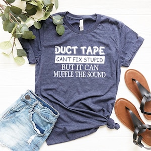 May include: A navy blue t-shirt with white text that reads "Duct Tape Can't Fix Stupid But It Can Muffle The Sound".