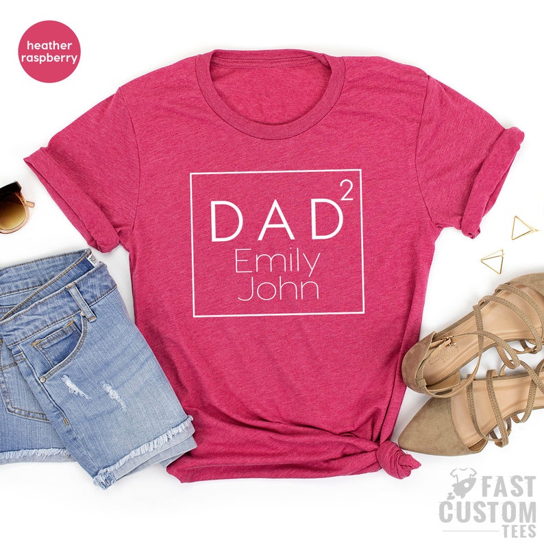 May include: Heather raspberry t-shirt with a white square graphic that says "DAD&sup2; Emily John"