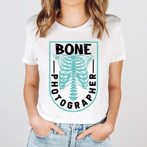 a woman wearing a white shirt with a skeleton on it