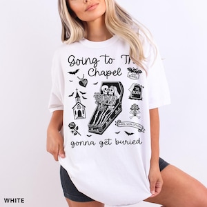 May include: White t-shirt with a black graphic design featuring the text "Going to the Chapel gonna get buried." The design includes bats, a church, a coffin with skeletons, and other gothic elements.