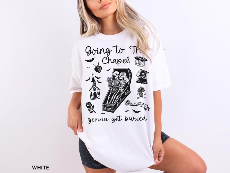 May include: White t-shirt with a black graphic design featuring the text "Going to the Chapel gonna get buried." The design includes bats, a church, a coffin with skeletons, and other gothic elements.