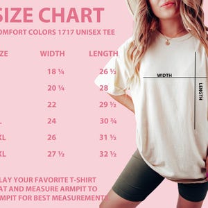 May include: A size chart for a Comfort Colors 1717 unisex tee, with measurements in inches for sizes S through 3XL. The chart is on a pink background, with the text "SIZE CHART" at the top. The image also shows a person wearing the tee.
