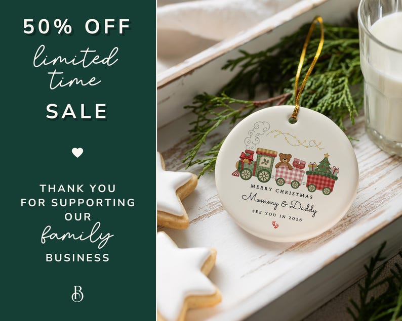 May include: A white ceramic Christmas ornament with a train design, featuring a teddy bear and Christmas tree. The ornament has the text "Merry Christmas Mommy & Daddy See You in 2026". The image also includes star-shaped cookies and text that says "50% OFF limited time SALE".