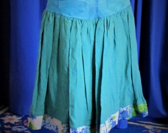 Upcycled denim skirt: Turquoise jeans with shot linen and floral linen border.