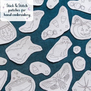 May include: A collection of white stick and stitch embroidery patches featuring Halloween-themed line art designs including pumpkins, bats, a cat, a spider, a moth, candy, and a witch hat, with the text Stick & Stitch patches for hand embroidery.
