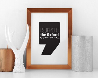 May include: A copper-framed print with a black and white graphic of a quotation mark. The text on the print reads "I support the Oxford comma."