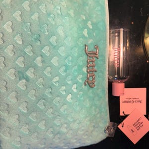 NEW Juicy Couture Travel Cosmetic Bag- Pale Teal Color, soft felt texture, comes with travel size bottle.