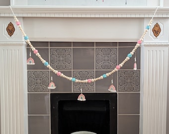 Wooden beaded garland with rainbow charms.
