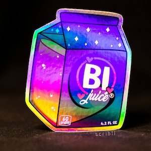 May include: A holographic sticker of a carton of juice with the text "BI juice" and a rainbow gradient design. The carton has a white heart with a pink outline on the front and the text "4.2 FL OZ" on the bottom.