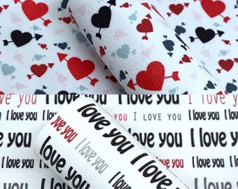 May include: White faux leather sheets with a repeating pattern of red, black, and blue hearts pierced by arrows. The bottom section features the text "I love you" in various fonts and colors.