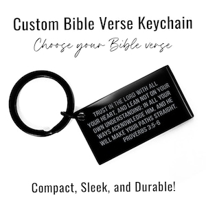 May include: Black metal keychain with a silver inscription that reads "TRUST IN THE LORD WITH ALL YOUR HEART, AND LEAN NOT ON YOUR OWN UNDERSTANDING: IN ALL YOUR WAYS ACKNOWLEDGE HIM, AND HE WILL MAKE YOUR PATHS STRAIGHT. PROVERBS 3:5-6".