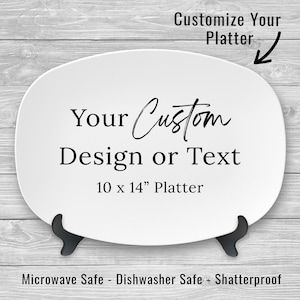 May include: White oval ceramic platter with black text that reads "Your Custom Design or Text" and "10 x 14" Platter". The platter is microwave, dishwasher, and shatterproof safe.