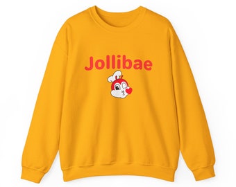 May include: A yellow sweatshirt with the words "Jollibae" printed in red on the front. A cartoon character with a red chef's hat and a red heart is also printed on the front.