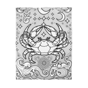 May include: Black and white line art illustration of a crab with a star on its back. The crab is surrounded by a decorative pattern of stars, moons, and waves.