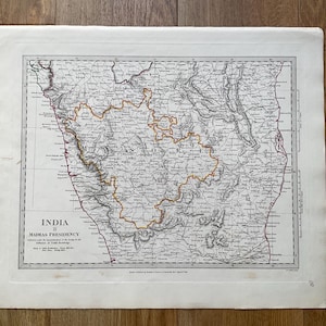 May include: An antique black and white map titled India II Madras Presidency, featuring detailed topography and a prominent orange outline highlighting the Mysore region. The map includes grid lines, geographical labels, and text.