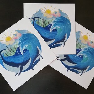 May include: Three watercolor prints of a blue wave crashing over a mountain range with a yellow sun and pink clouds in the sky.  Three whales are swimming in the wave.