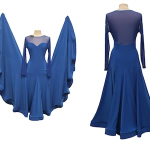 May include: A royal blue dance dress with long sleeves and a flowing skirt. The dress features a sheer neckline and back, and is displayed on a mannequin. The dress is designed for ballroom or stage performance.