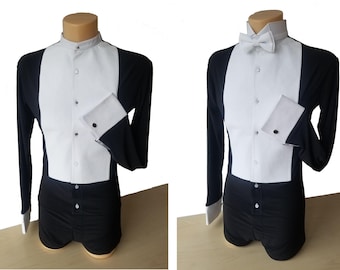 May include: A black and white dress shirt with a white collar and cuffs. The shirt has a black bow tie and a white front panel. The shirt is worn by a mannequin.