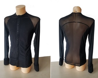 May include: A black long-sleeved shirt with a mesh panel on the back. The shirt has a mandarin collar and button closure.