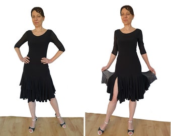 May include: A black dance dress with a ruffled skirt and a slit up the front. The dress has three-quarter sleeves and a scoop neckline.
