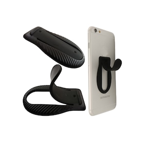 May include: A black phone stand with a textured surface. The stand can be folded to prop up a phone in a vertical position. The stand is shown attached to a white smartphone.