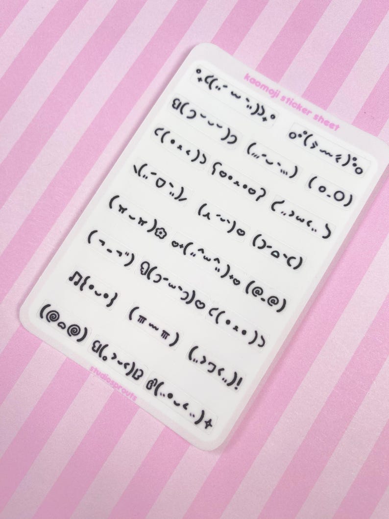May include: A white sticker sheet with various black kaomoji emoticons. The sheet has the text "kaomoji sticker sheet" and "studiosprouts". The background is a pink and white striped pattern.