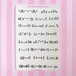 May include: A white sticker sheet with various kaomoji emoticons in black. The sheet has the text "kaomoji sticker sheet" at the top. The background is a pink and white striped pattern.