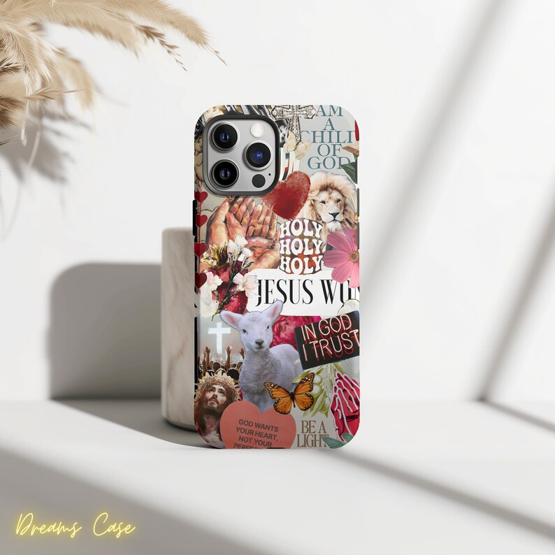 May include: A colorful phone case with a collage of religious imagery, including a lamb, a cross, a butterfly, and the words "Jesus Will", "In God I Trust", and "Be A Light".