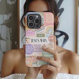 May include: A phone case with a collage of pastel-colored stickers and text. The stickers include phrases like "Jesus Won," "God Falls You Worthy," and "Trust Jesus." A rainbow and cross are also visible.