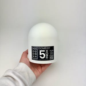 May include: A white ceramic dome mold, 5 inches in diameter, for ceramics. The product has a black and white label with the text "MM OONN CERAMICS" and "DOME MOLD". Includes a QR code for tool information.