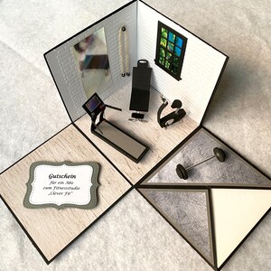 May include: A handmade papercraft diorama of a gym, featuring a treadmill, weight bench, and exercise bike. The scene includes a barbell and a gift certificate with text. The walls are white with a brick pattern, and the floor is light wood.