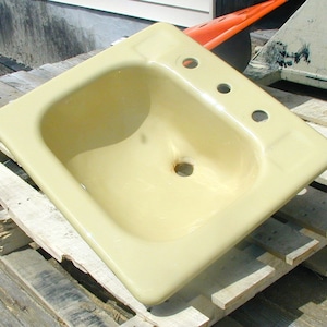 Yellow bathroom sink, cast iron drop-in style, original porcelain (small chip)