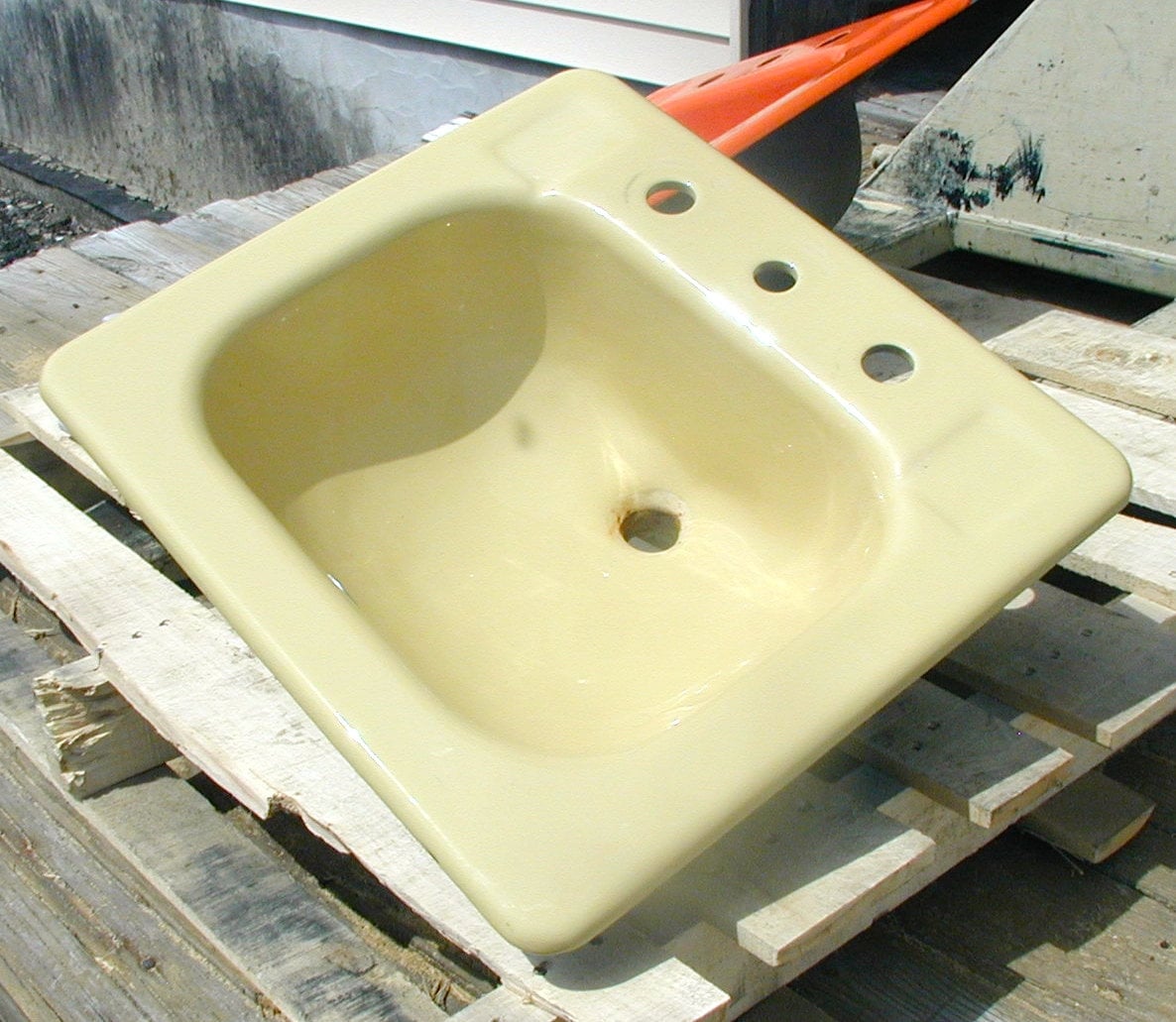 Yellow bathroom sink, cast iron drop-in style, original porcelain (small chip)