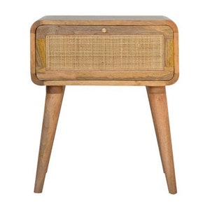 May include: A wooden bedside table with a single drawer featuring a woven rattan front. The bedside table has rounded edges and tapered legs.